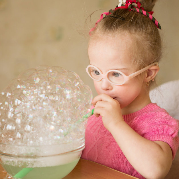 little girl playing with bubbles